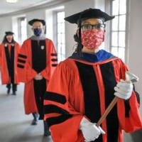 Three people in academic robes