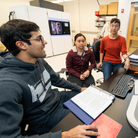 Molecular biologist Liz Kellogg and two students