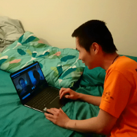  Student with computer, talking by video chat