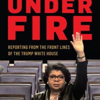 Cover of &quot;Under Fire&quot; book, with April Ryan holding her arm up to ask a question