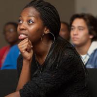 Female Black student listening to talk