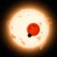  A large sun shines behind a red planet and a smaller black planet in space