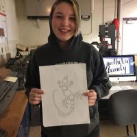  Olivia Lowman, winner of contest, holds up winning gecko design