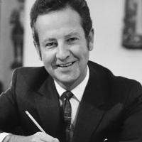 Robert Plane smiling, holding a pencil