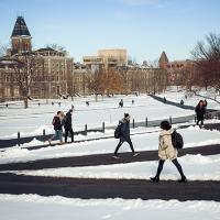 students walk across the arts quad in winter