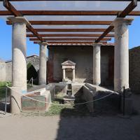 Garden triclinium (outdoor dining benches) at the Casa dell’Efebo, a wealthy house in Pompeii. Paintings of Egyptian landscapes decorate the sides of the benches where people once reclined to dine, and an artificial canal once flowed between the benches.