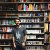 Student in front of shelf full of video games