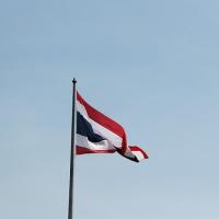 Flag of Thailand against a pale blue sky