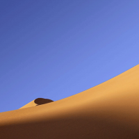 Sand dune under a blue sky