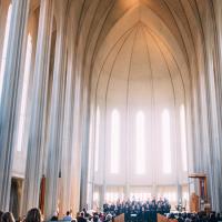 people congregated in a vaulted church sanctuary