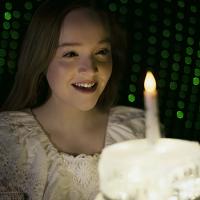 Girl looking at birthday cake