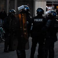 Four police in black, with shields and helmets