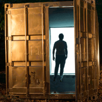 Student standing in doorway of cargo container