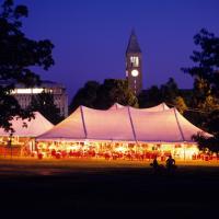 Big tent on the Arts Quad with lots of alumni