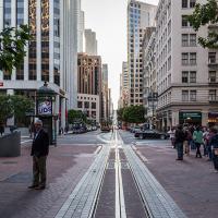 Street scene in San Francisco; tall buildings and cable car track