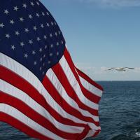 US Flag flying over the ocean