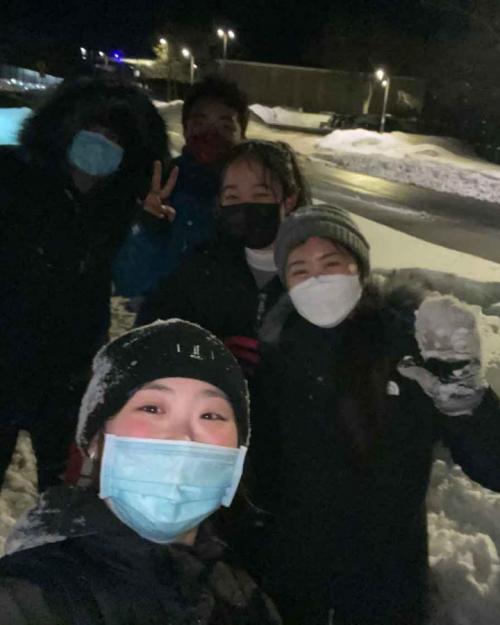Students with masks on in snow