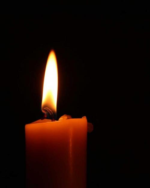 Candle and flame, dark background