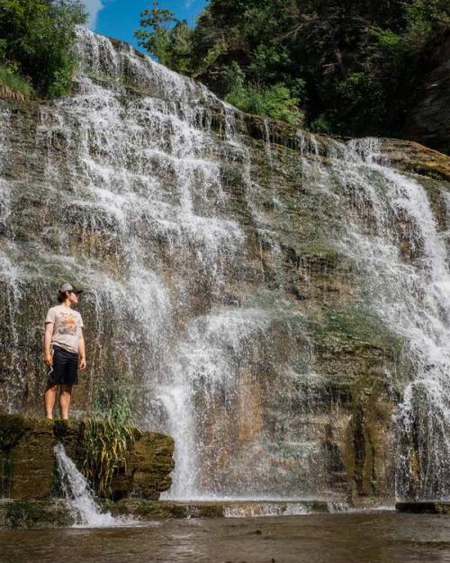 person near waterfall