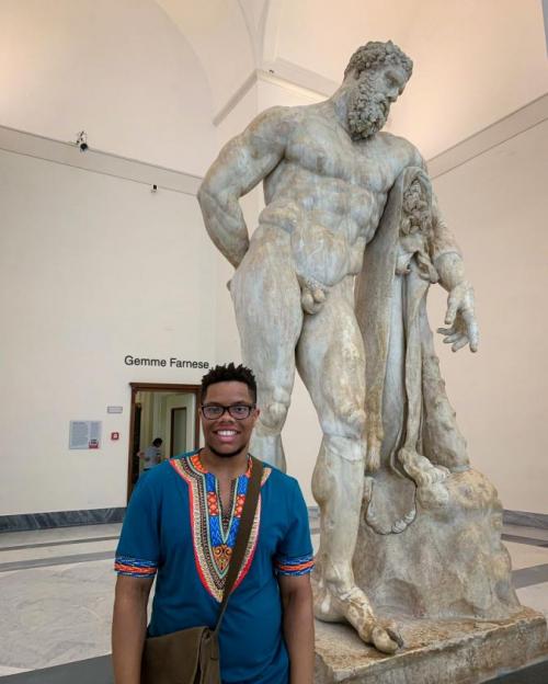 man by Greek statue