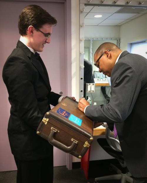 student getting instrument signed by Wynton Marsalis