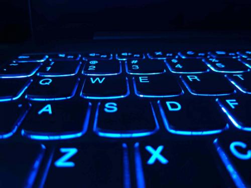 Part of a keyboard lit with blue light