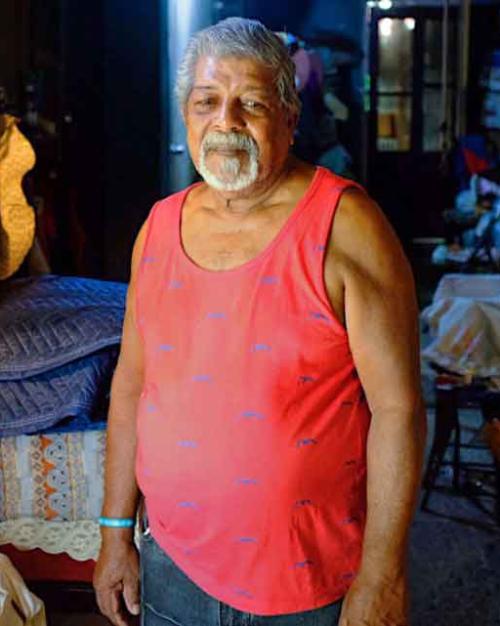 man standing near fish tank