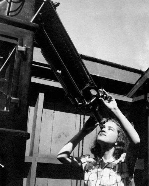 girl looking into telescope