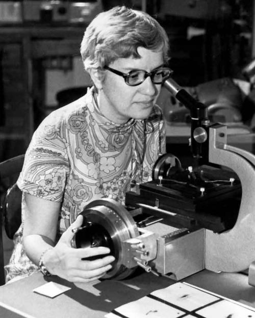 woman looking into microscope
