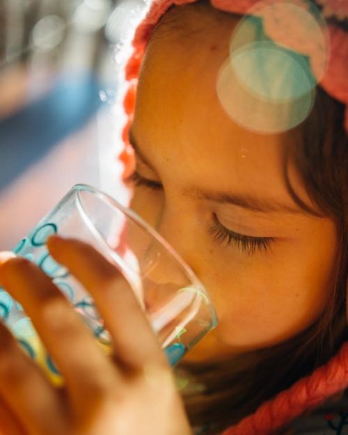 Child drinking water from a glass