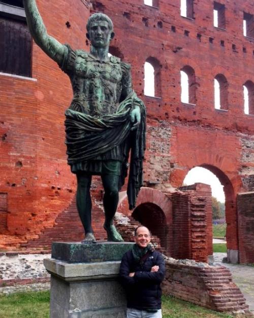 Person standing in front of an ancient Roman statue