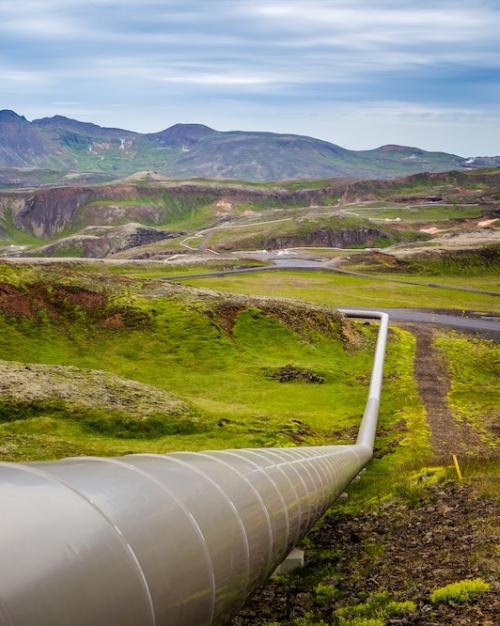 above-ground pipeline extends across a rugged landscape