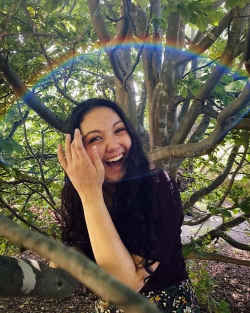 woman surrounded by rainbow