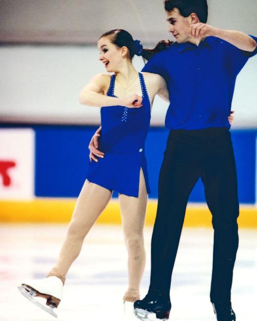 Two people on ice skates, performing