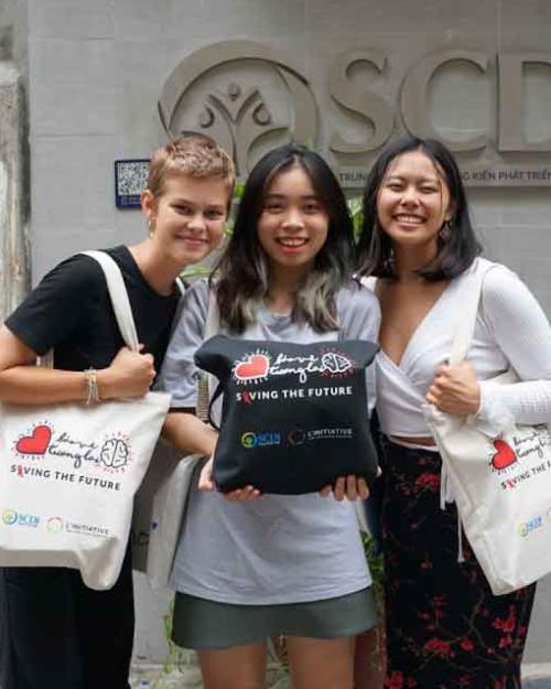 three women with tote bags