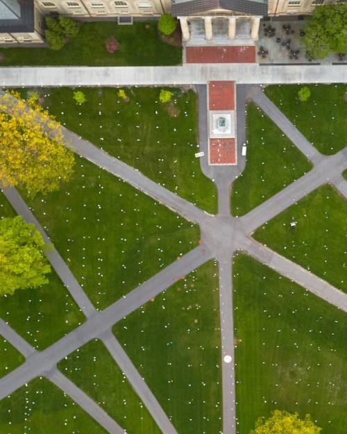 Aerial view of Cornell's Arts Quad, showing green lawn and grey paved paths
