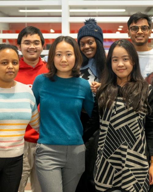 Eight students face forward