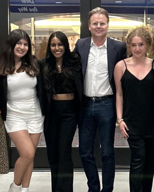		Nine people standing in a line, wearing fashionable outfits
	
