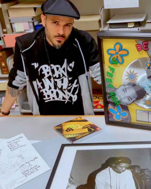 		person sitting with records and other items around them
	