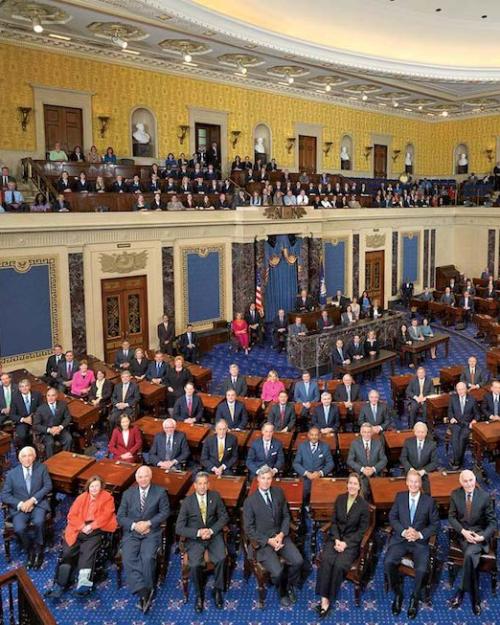 		The U.S. Senate chamber (blue carpet, yellow walls) with the Senators seated at their deks
	