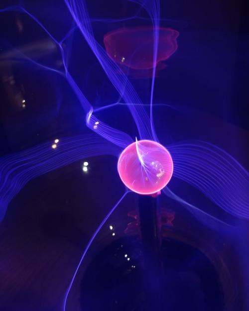 		pink ball suspended in a purple field
	