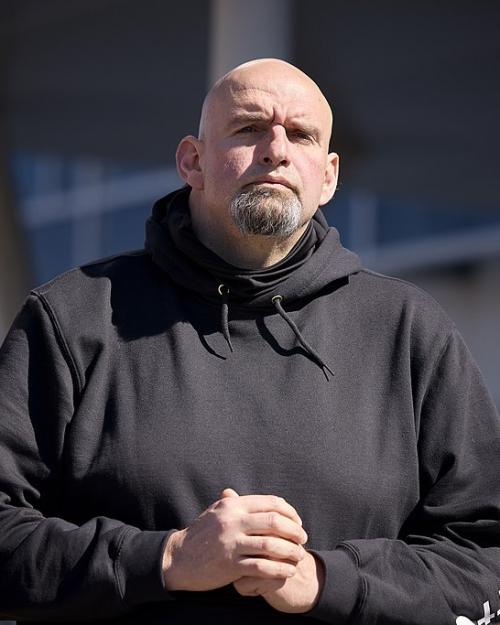 		Large person wearing a dark hoodie sweatshirt and a frowning expression
	