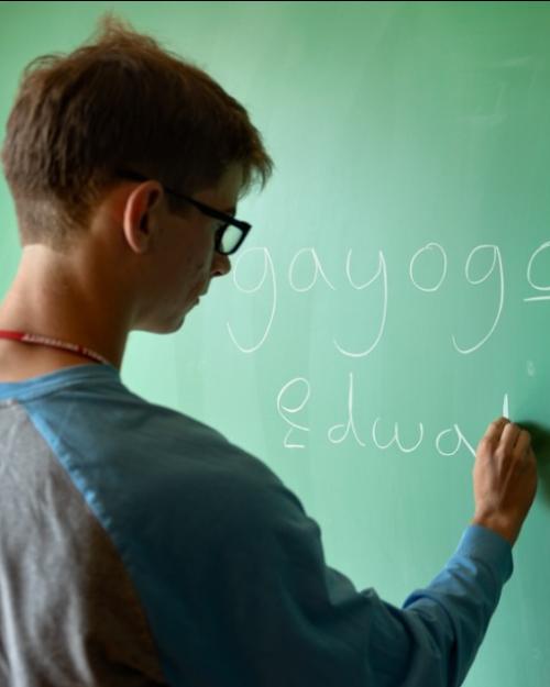 		person writing on chalkboard
	
