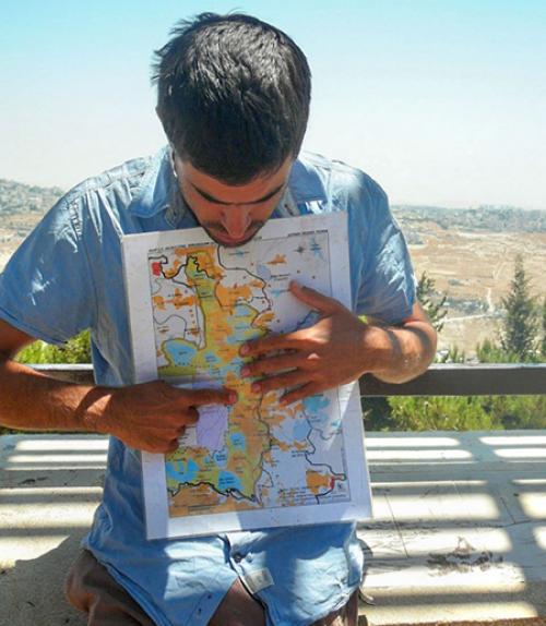 Person holds a map and points to it