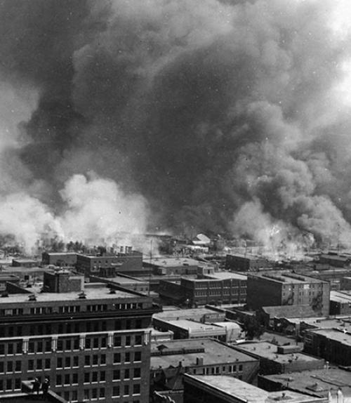  Historic photo: Smoke billows beyond city buildings