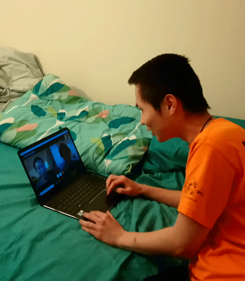 Student with computer, talking by video chat