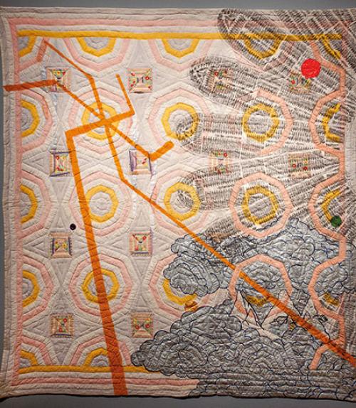 Quilt depicting orange lines and slave ships in a half circle facing out