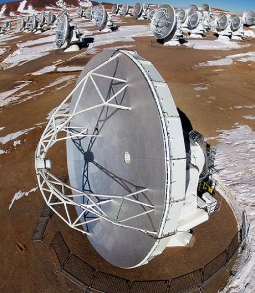  One of the ALMA telescopes in foreground with others in background