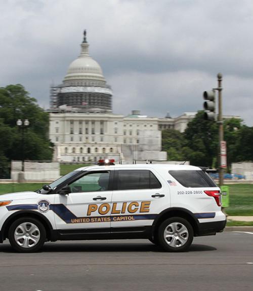 Police vehicle in front of U.S. Capitol building