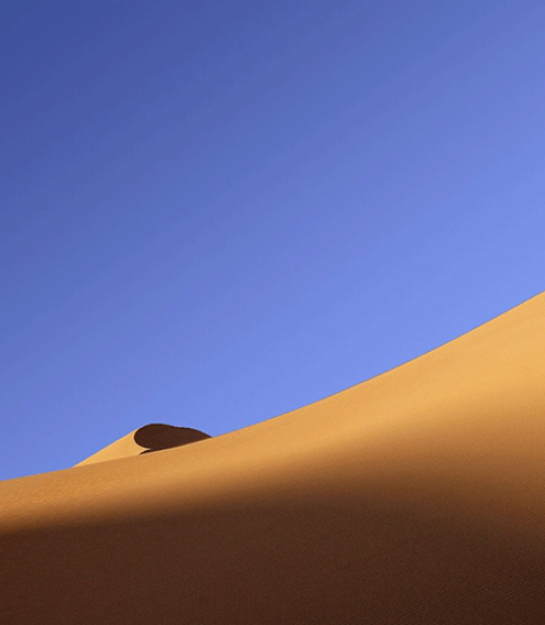 Sand dune under a blue sky